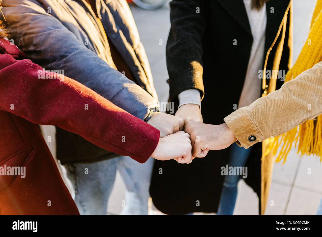 Close up group of young students stacking hands together Stock Photo