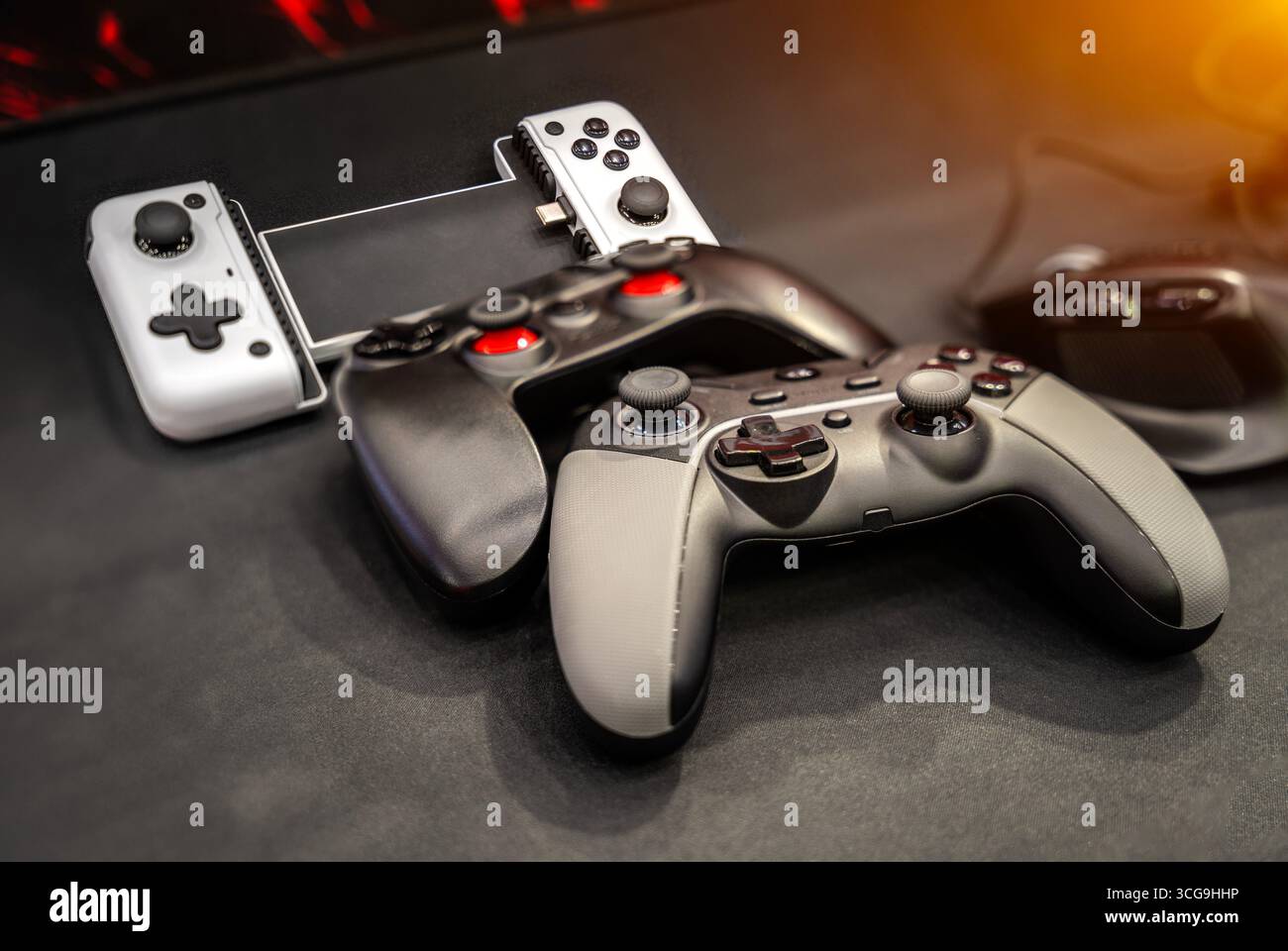 Next Generation joystick game controllers on black background. Stock Photo