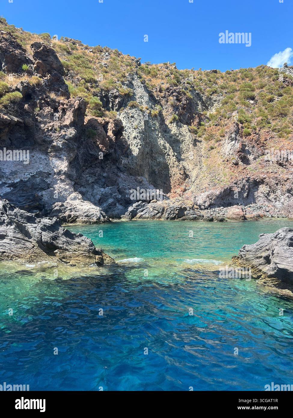 Natural pool called 'Piscina di Venere' on Vulcano Island, Aeolian Islands, Sicily, Italy, on a sunny summer day. - Smartphone Captured Stock Image