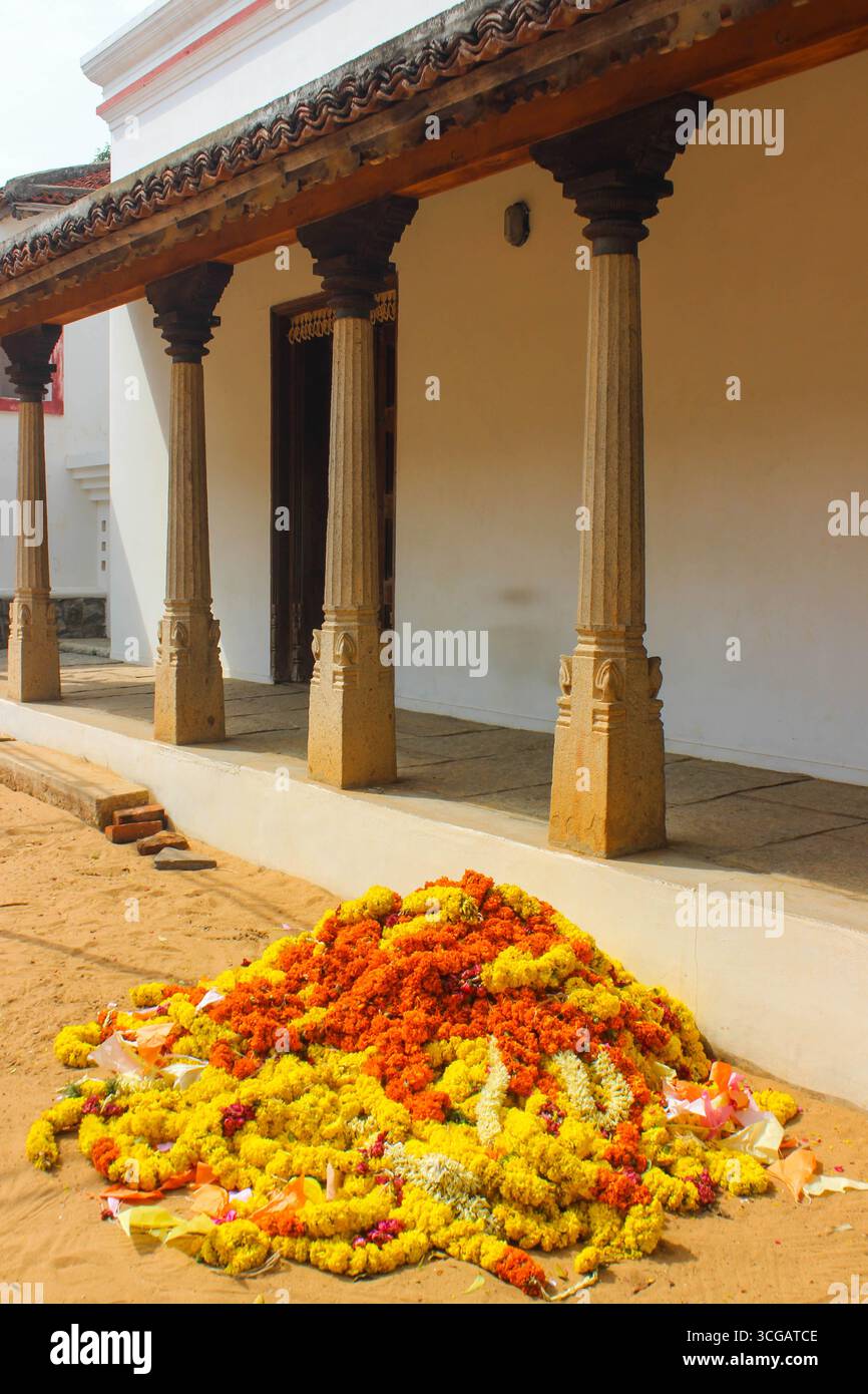 Traditional South Indian homes with sloping tiled roofs, wooden pillars, courtyards, and vibrant cultural details, reflecting regional architecture and heritage. Stock Photo