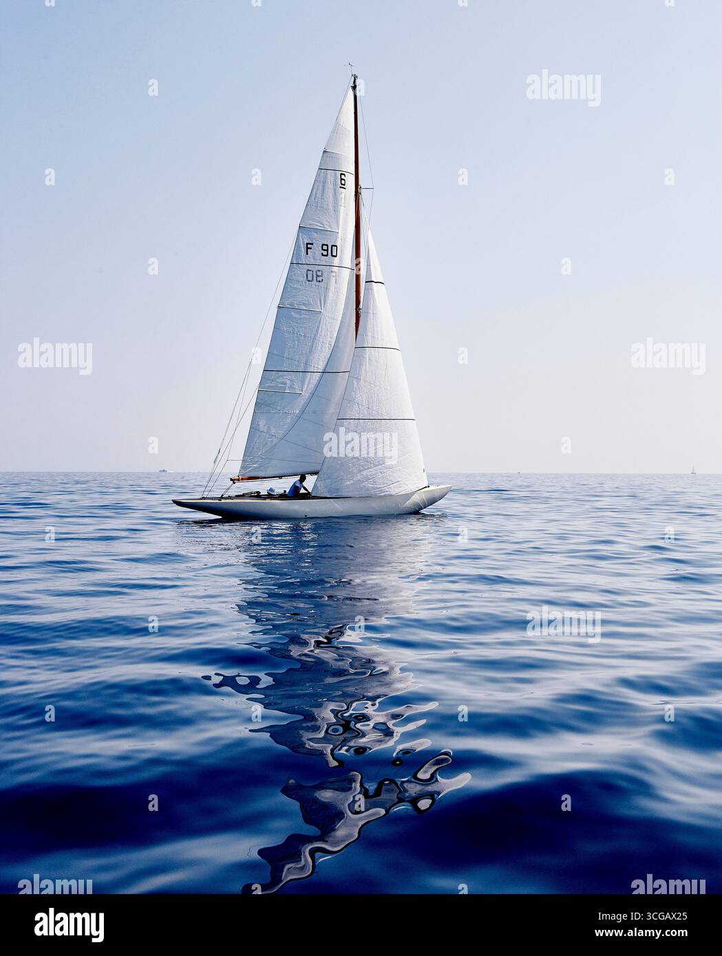 Elegant Sailboat on Calm Waters under a Clear Blue Sky Stock Photo - Alamy