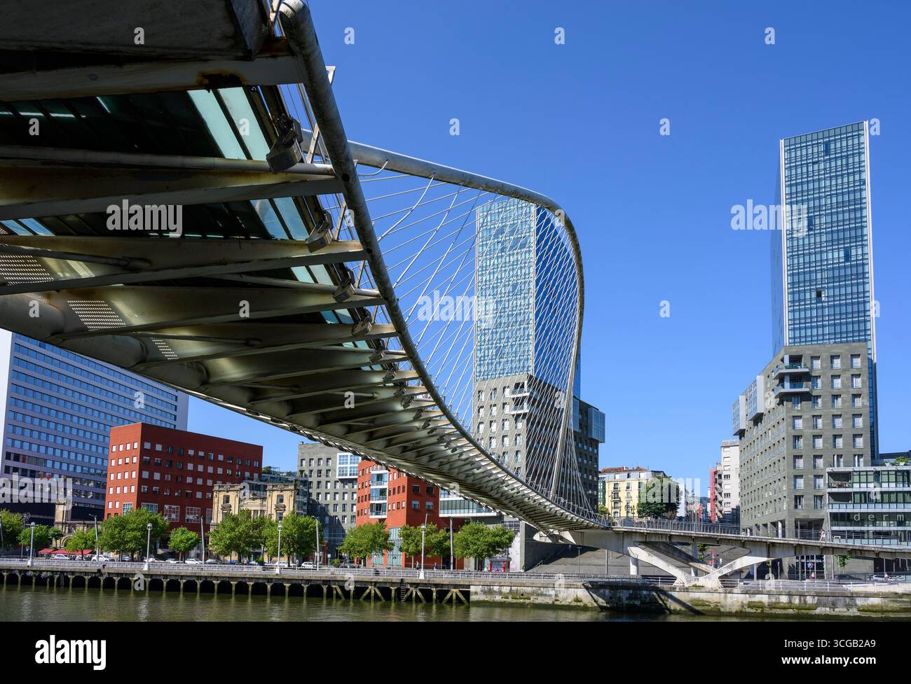 The Zubizuri (White) footbridge also known as the Calatrava bridge, after the architect Santiago Calatrava, spanning the Nervion River with the Isozak Stock Photo