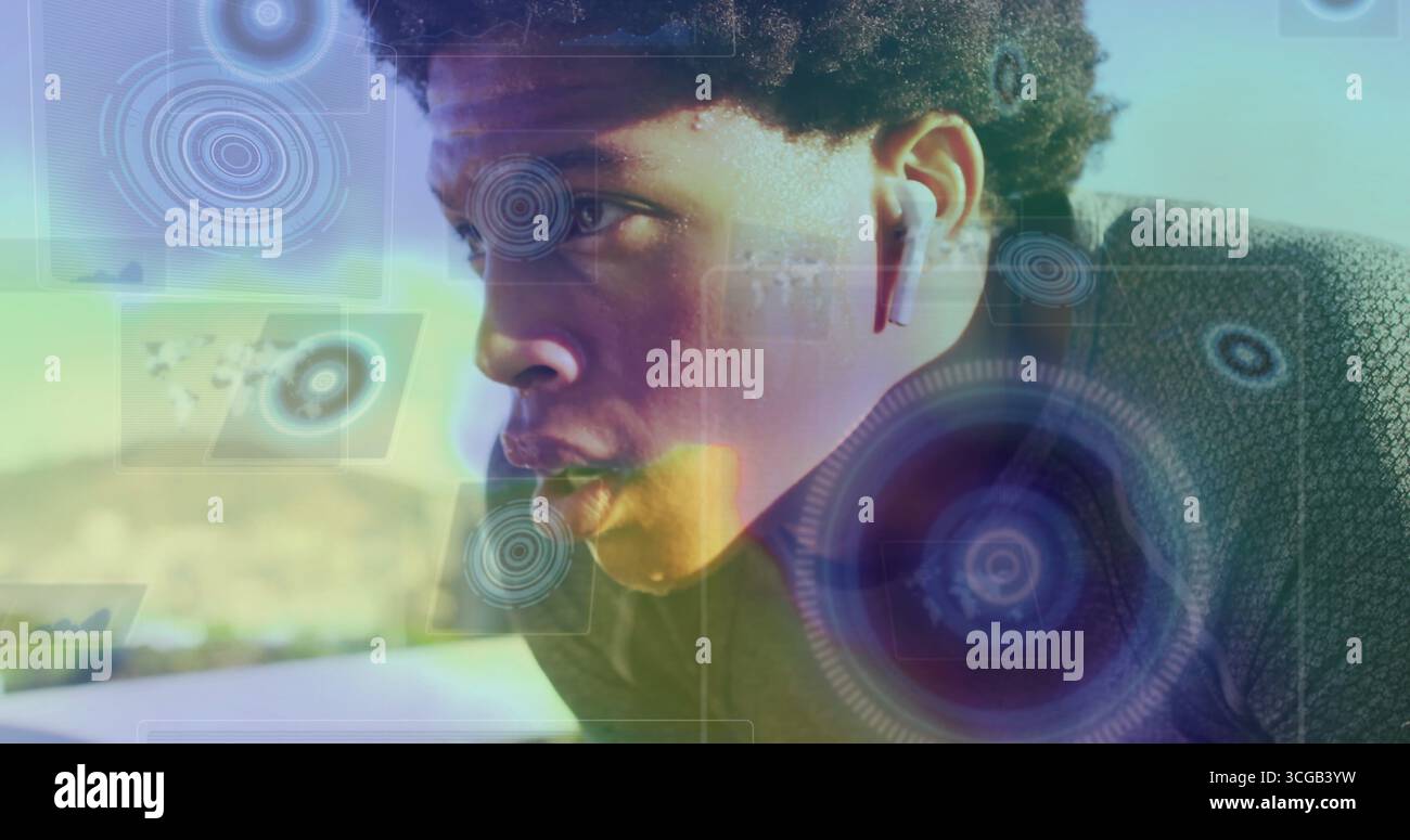 Running male athlete wearing running top on sunlit path, with wireless ...