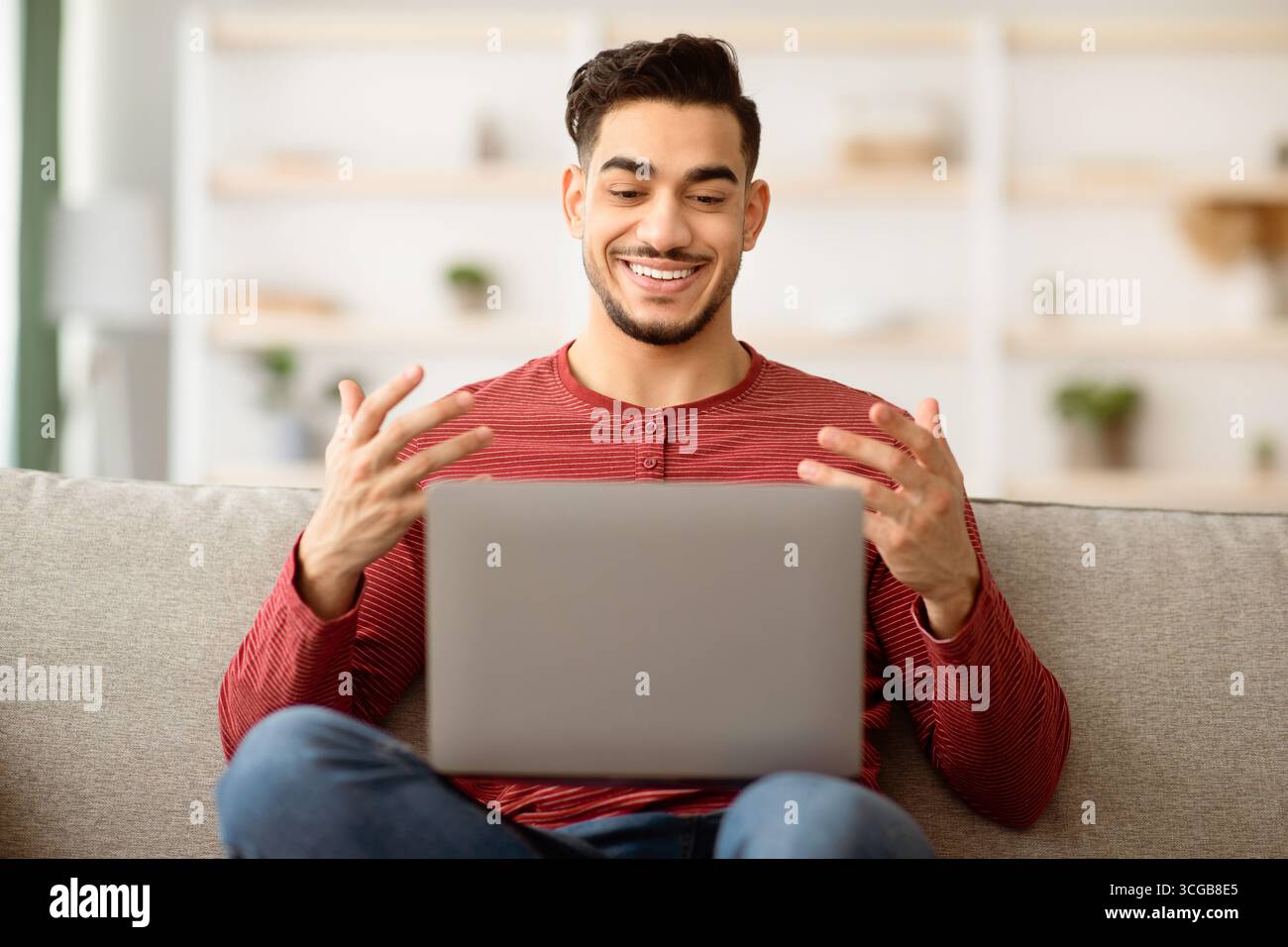 Positive arab guy having video chat with girlfriend Stock Photo