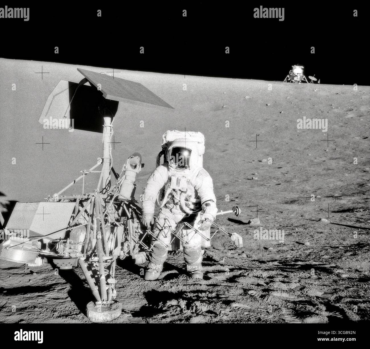 Charles Conrad Jr., Apollo 12 Commander, examines the unmanned Surveyor ...