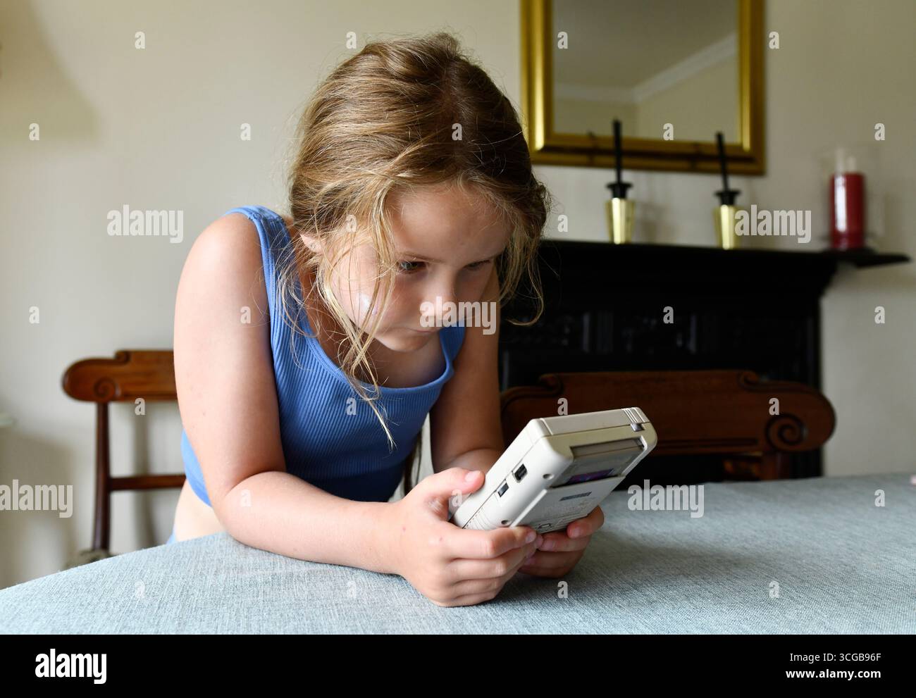 Child playing with a vintage 1980s Nintendo Gameboy Stock Photo