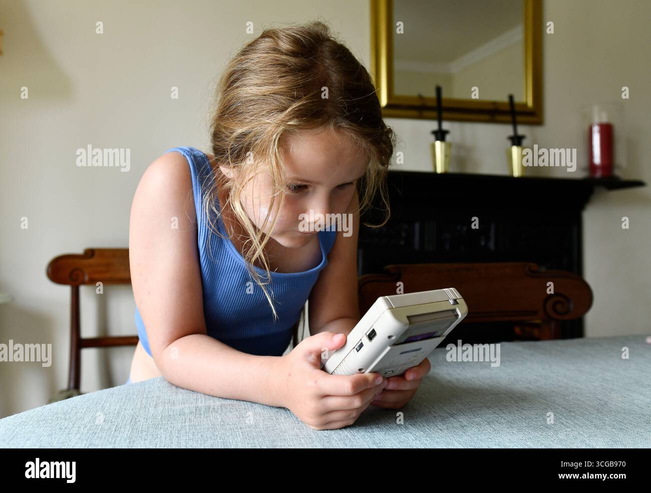 Child playing with a vintage 1980s Nintendo Gameboy Stock Photo