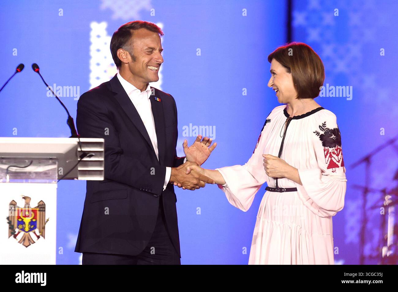 French President Emmanuel Macron shakes hands with Moldova's President