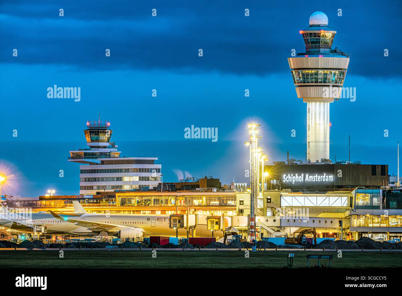 Schiphol Airport Air Traffic Control Tower of Schiphol Amsterdam International Airport at night. Airport towers at Amsterdam Schiphol Airport. Stock Photo