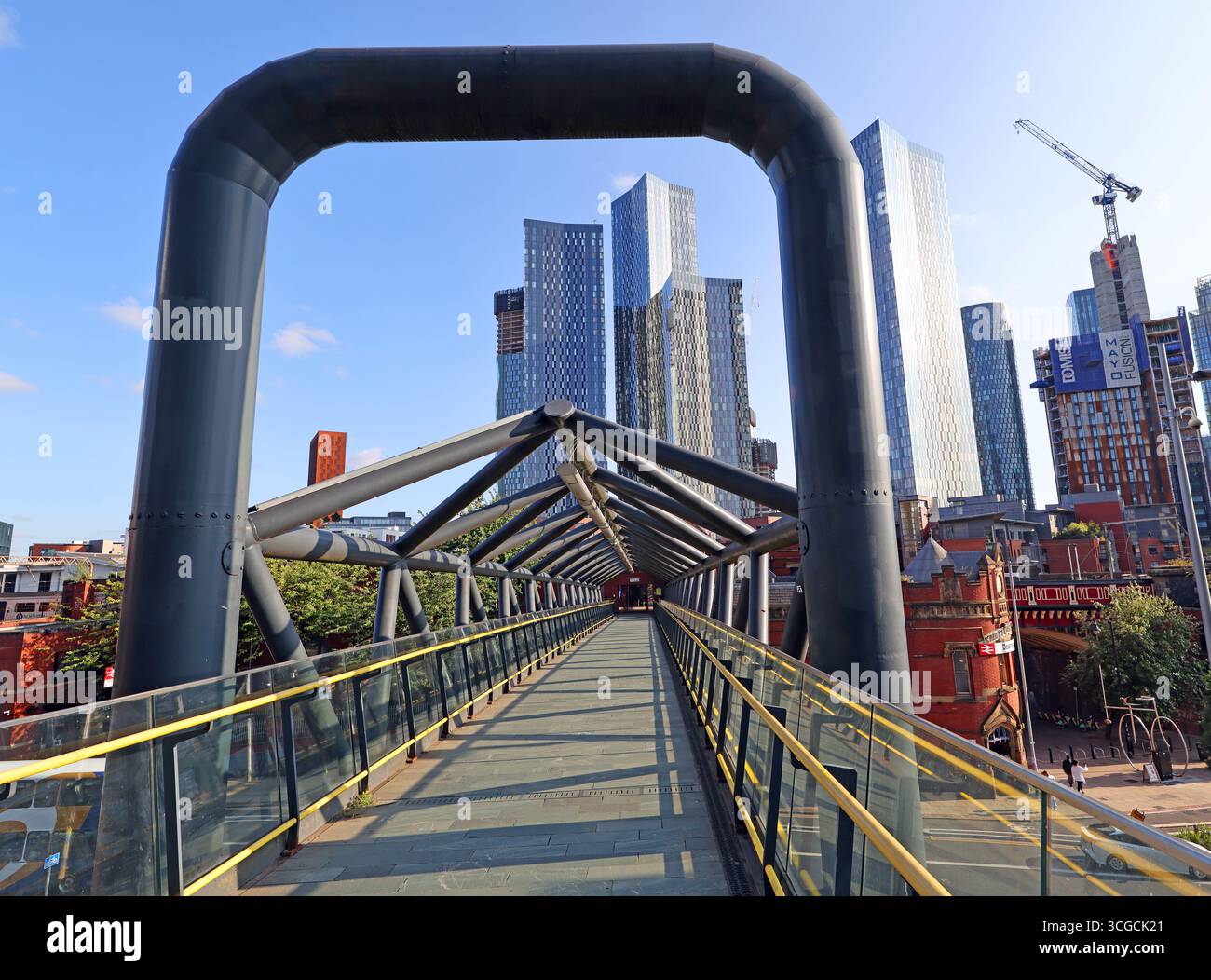 Pedestrian walkway at Castlefield in Manchester city centre linking the Metrolink tram stop with National Rail services at Deansgate Station Stock Photo