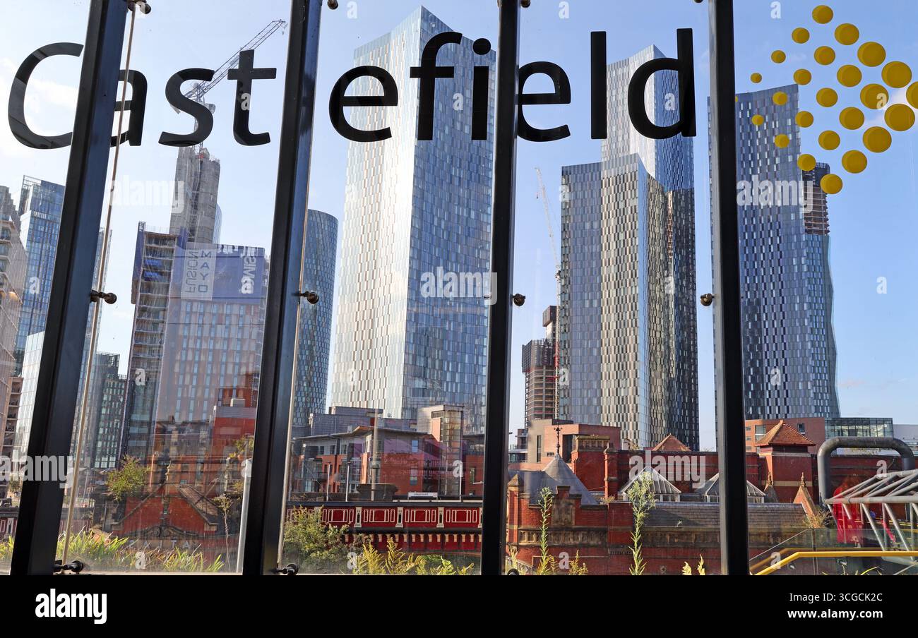 View from Castlefield looking towards Deansgate and Manchester’s modern skyline on a warm summer evening in August. Historic red-brick buildings Stock Photo