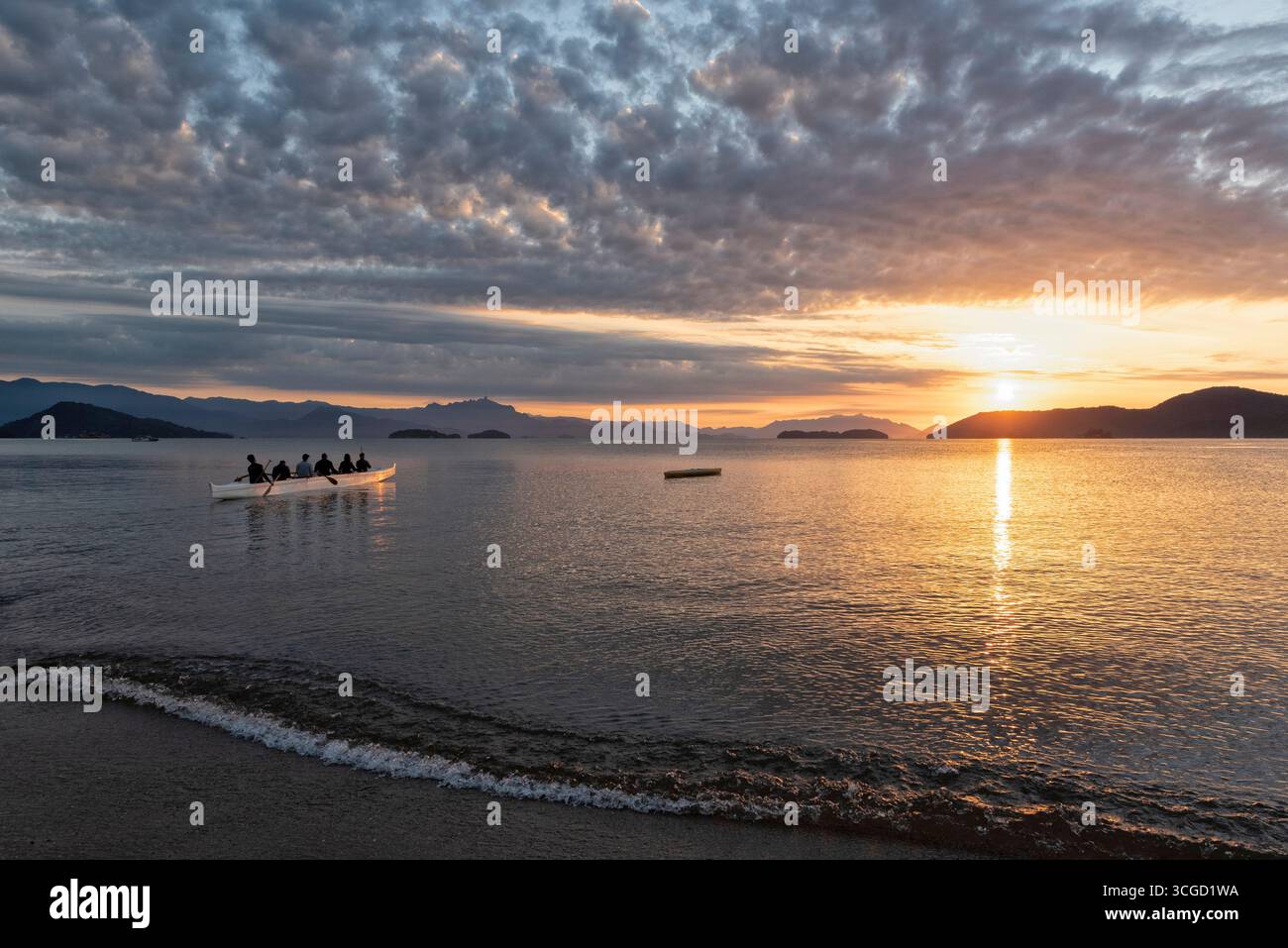 Group of people on rowing boat during sunrise Stock Photo - Alamy