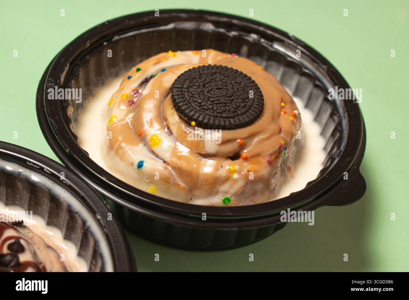 A gourmet cinnamon roll pastry covered in white frosting and sweet ...