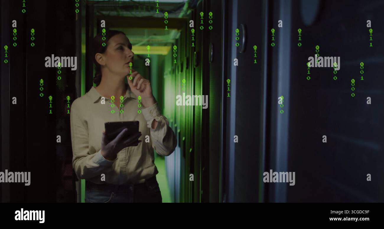 Analyzing IT engineer in jeans holding tablet in server corridor, with racks cables binary overlay Stock Photo