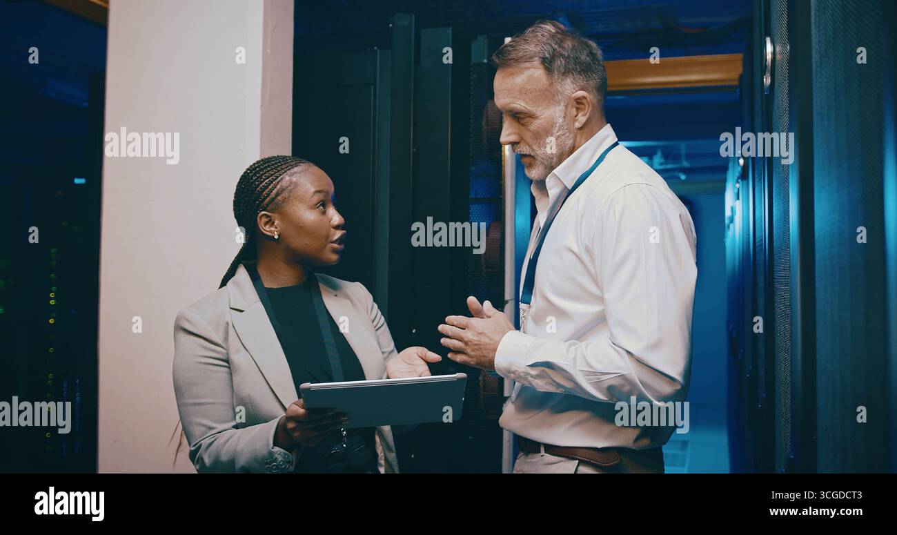 Tablet, team and people in data center for discussion, cloud computing or IT training with intern. Collaboration, tech or engineer in server room for Stock Photo