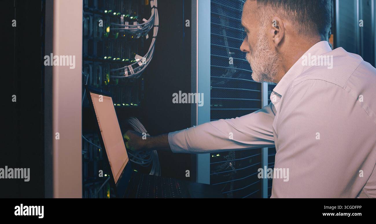 Cable, laptop and technician man in server room for cyber security, software update and database system. Programmer, developer and cybersecurity with Stock Photo