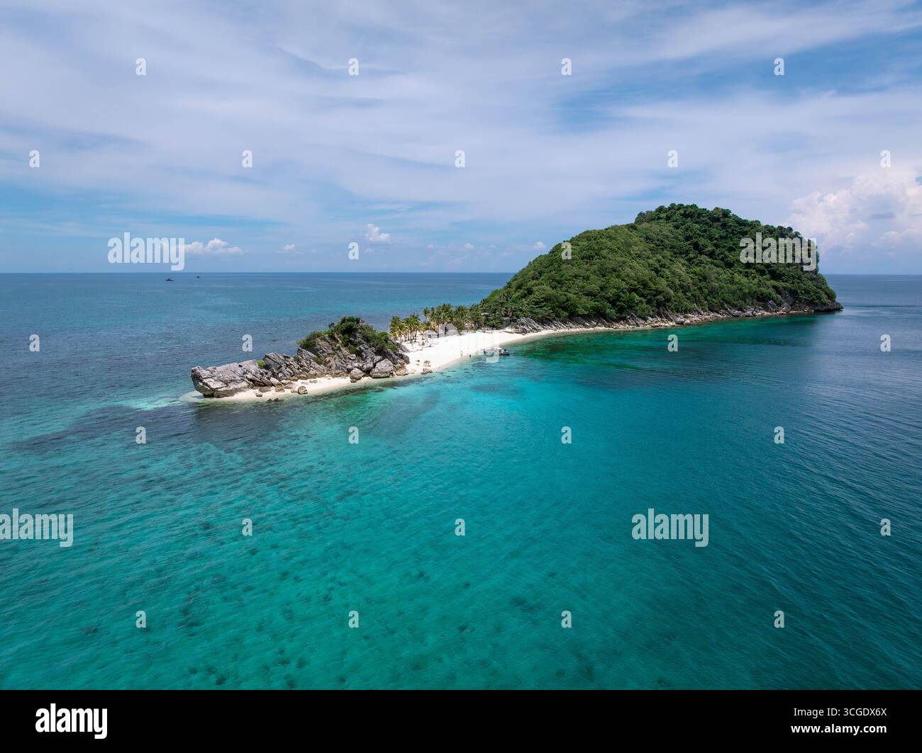 Aerial view of a secluded island with white sandy beaches meeting the ...