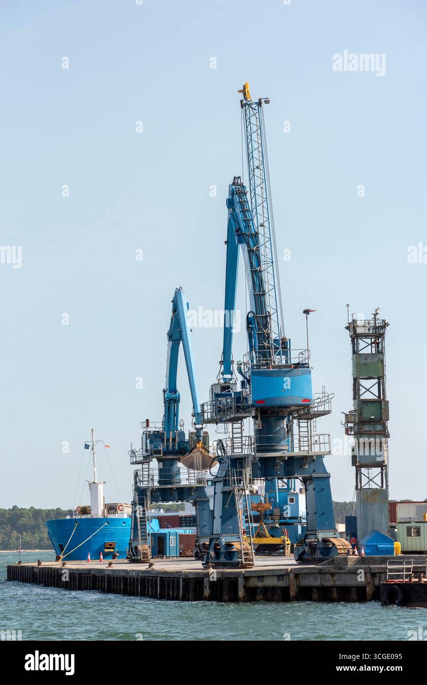 Poole Dorset England UK. 17.08.2025. Port of Poole  UK a ship moored alongside with large unmanned  cranes on the waterfront in Poole harbour Stock Photo