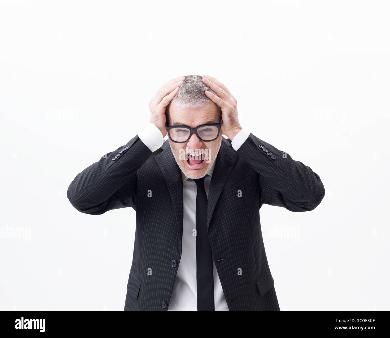 Portrait of a middle-aged businessman screaming and despairing, half-length isolated on white background Stock Photo