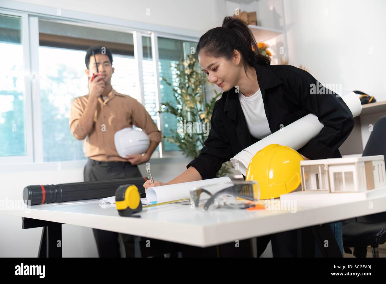 Engineers Reviewing Construction Plans and Models Stock Photo