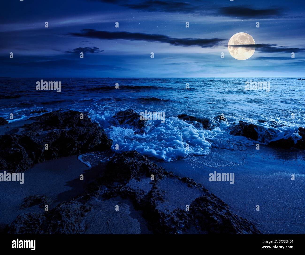 beach with sand at night. summer vacation at the seaside. beautiful seascape with calm waves in full moon light. landscape at the sea under sky with f Stock Photo