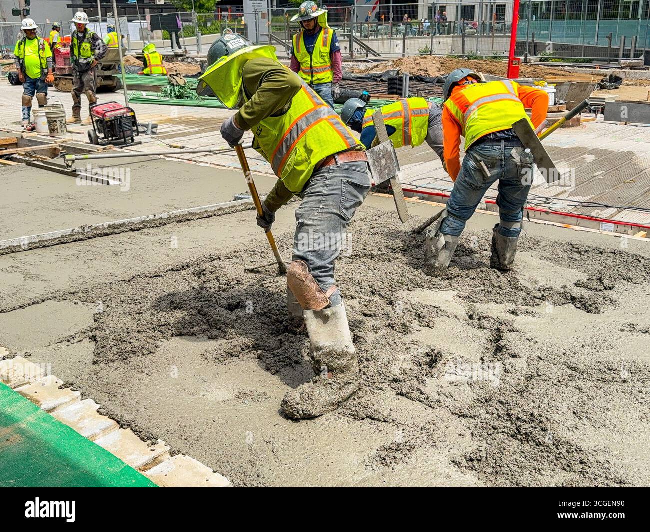 Denver, Colorado, USA - 4 June 2025: Construction workers laying concrete on a new roadway in downtown Denver - Smartphone Captured Stock Image