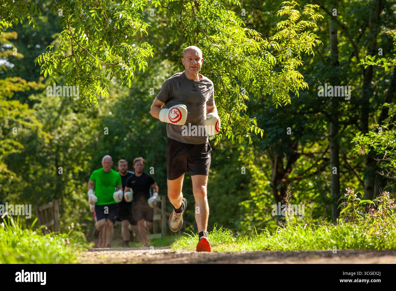 Man running in boxercise class, outdoors, aged 40 male Stock Photo - Alamy