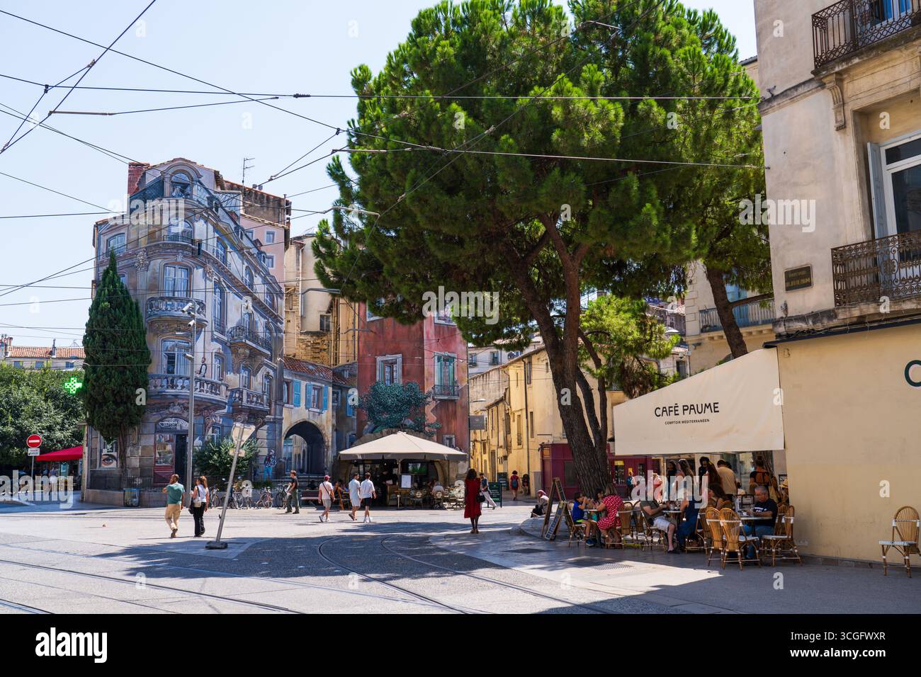 Montpellier, France - August 8th 2025: Boulevard Jeu de Paume near Place Edouard Adam, with the lightrail line, restaurants and typical buildings Stock Photo