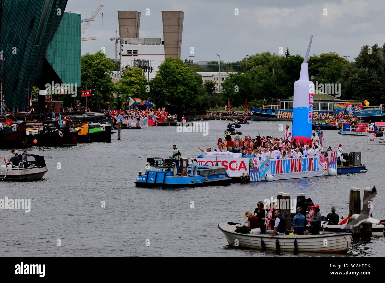 Float with inflatable syringe and costumed participants cruises Canal ...