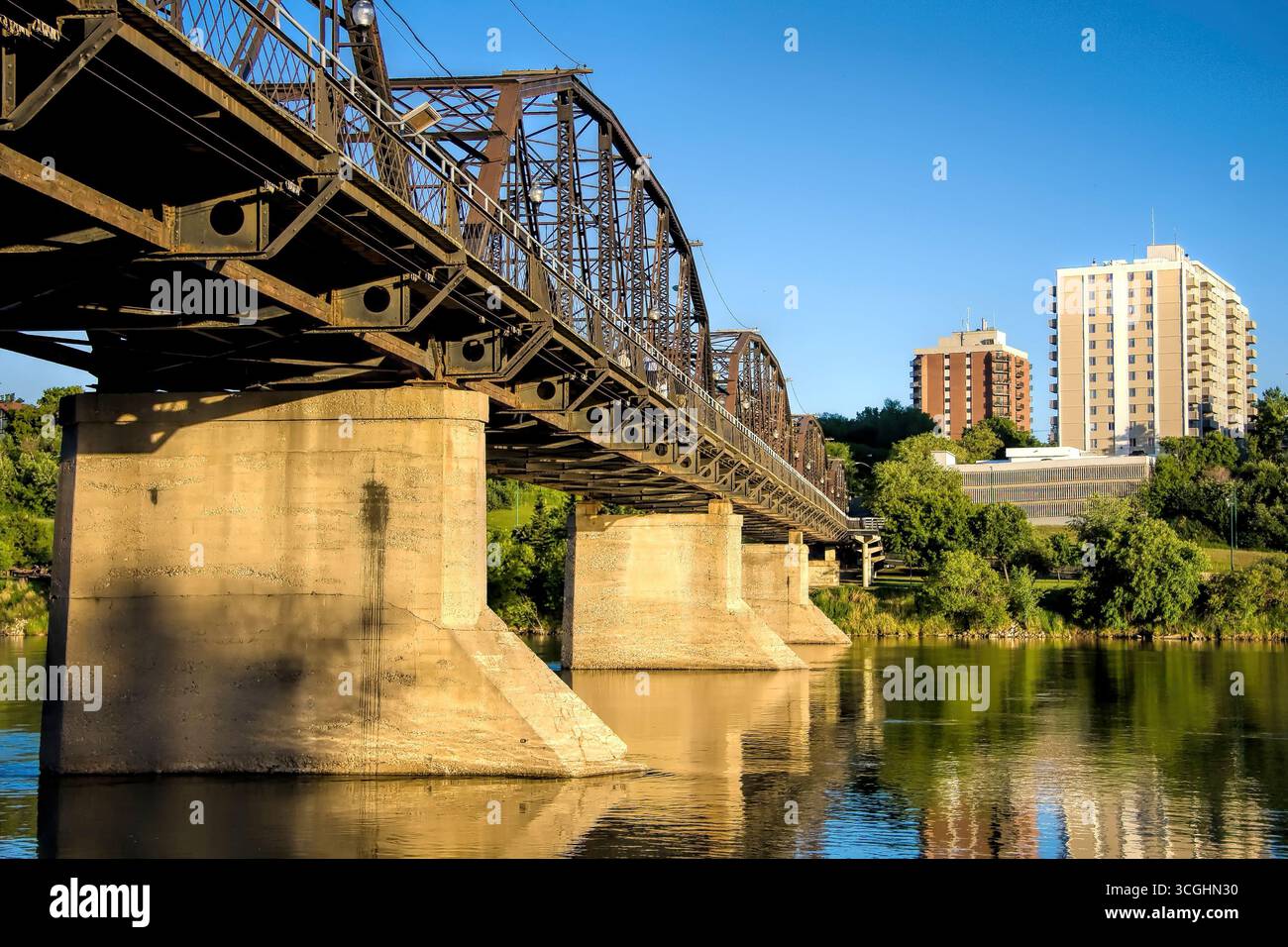 A modern steel structure, the rebuilt Traffic Bridge spans the South Saskatchewan River, reconnecting downtown Saskatoon with the east side. Stock Photo