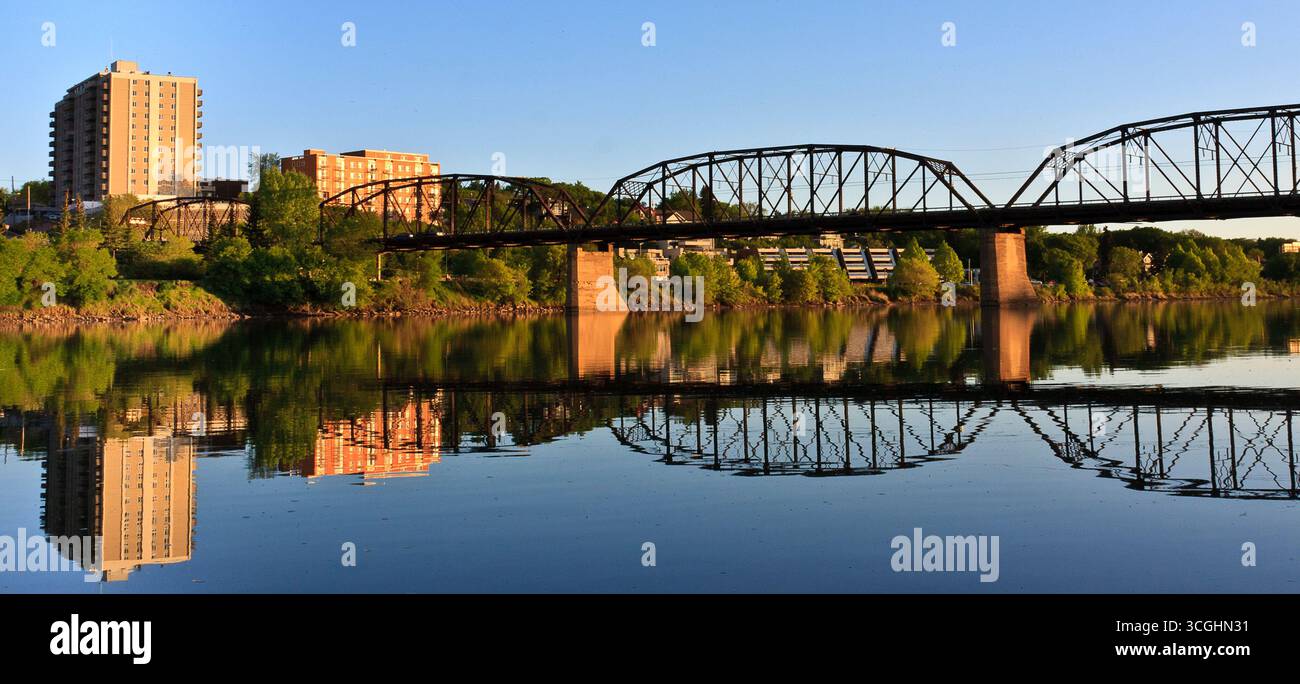 A modern steel structure, the rebuilt Traffic Bridge spans the South Saskatchewan River, reconnecting downtown Saskatoon with the east side. Stock Photo