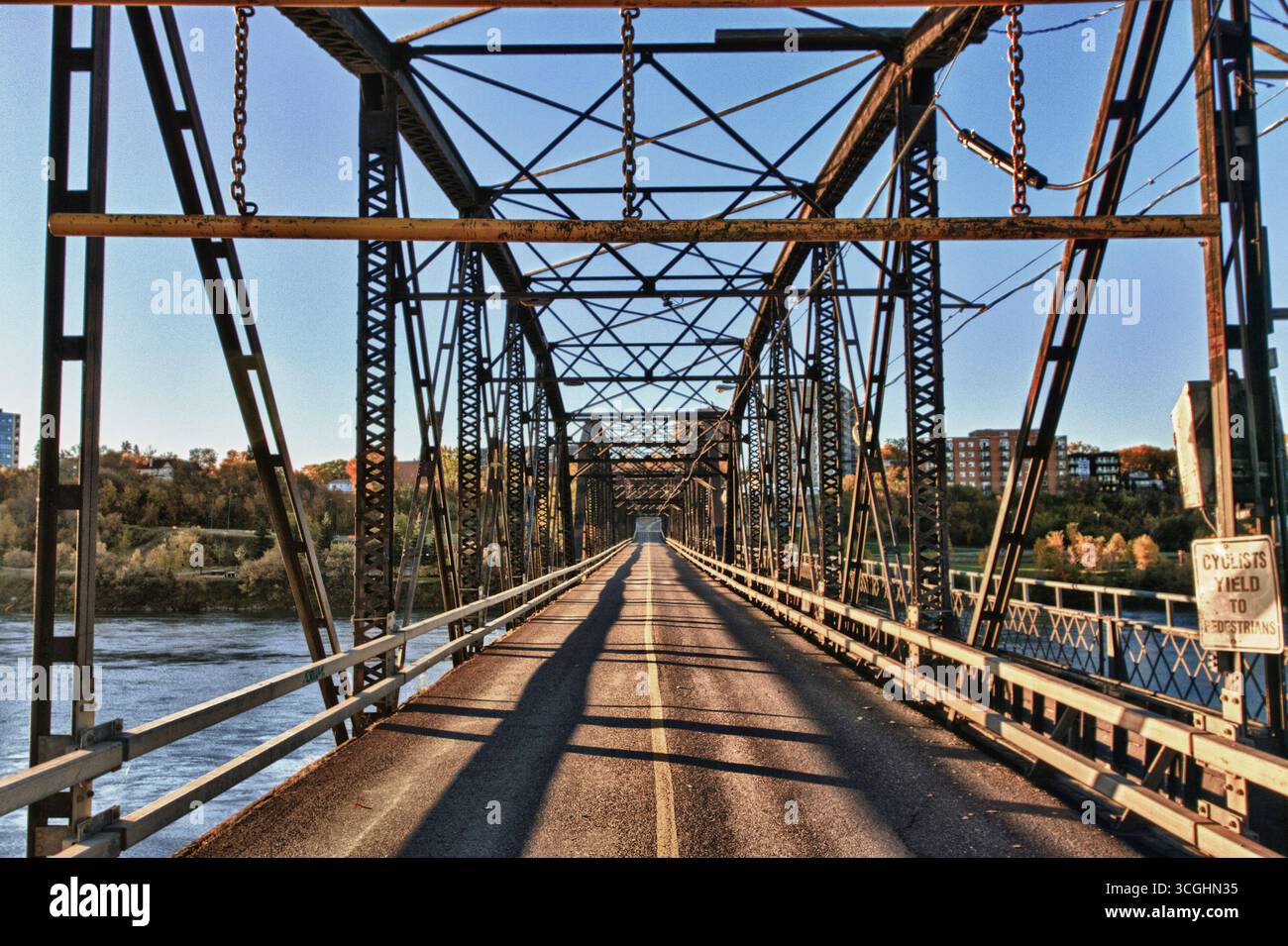 A modern steel structure, the rebuilt Traffic Bridge spans the South Saskatchewan River, reconnecting downtown Saskatoon with the east side. Stock Photo