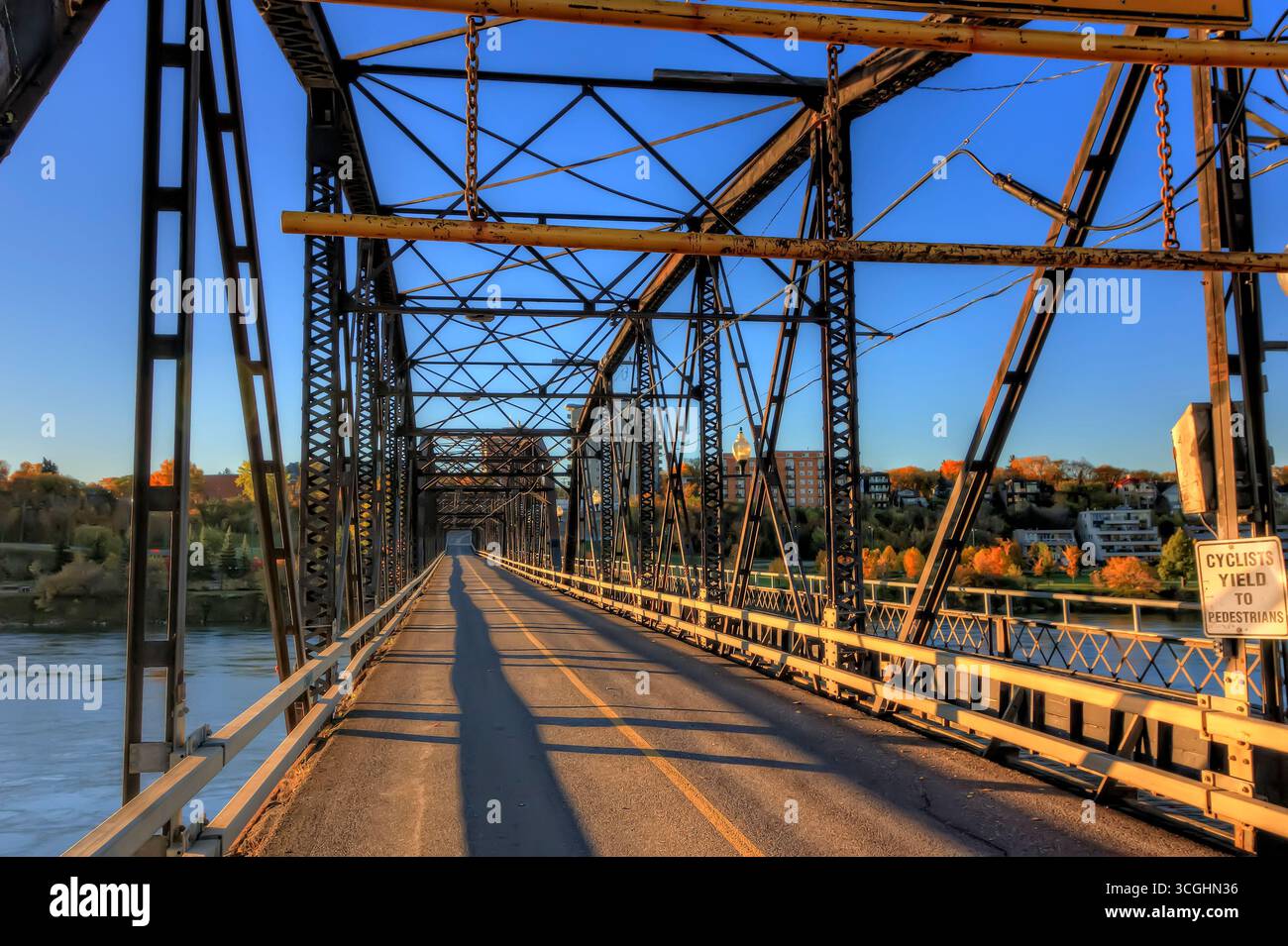 A modern steel structure, the rebuilt Traffic Bridge spans the South Saskatchewan River, reconnecting downtown Saskatoon with the east side. Stock Photo