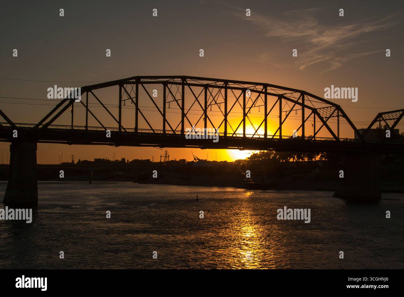 A modern steel structure, the rebuilt Traffic Bridge spans the South Saskatchewan River, reconnecting downtown Saskatoon with the east side. Stock Photo