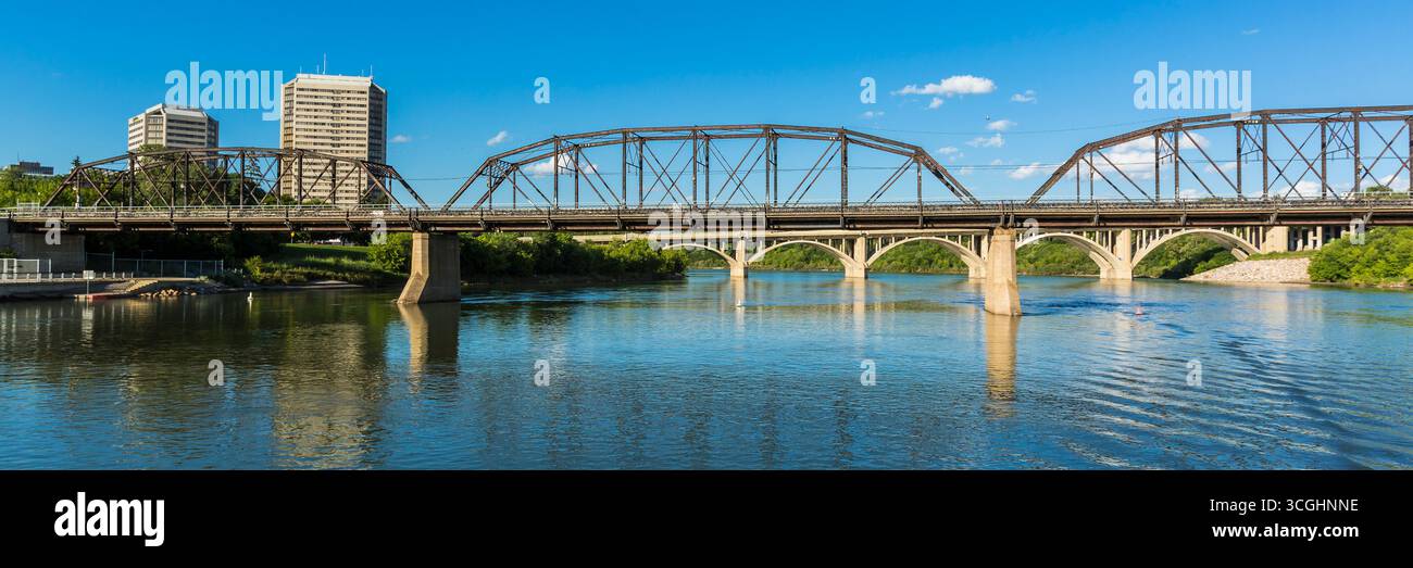 A modern steel structure, the rebuilt Traffic Bridge spans the South Saskatchewan River, reconnecting downtown Saskatoon with the east side. Stock Photo