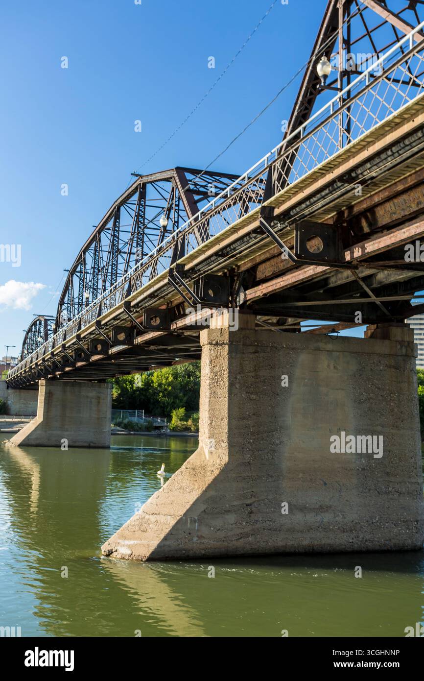 A modern steel structure, the rebuilt Traffic Bridge spans the South Saskatchewan River, reconnecting downtown Saskatoon with the east side. Stock Photo