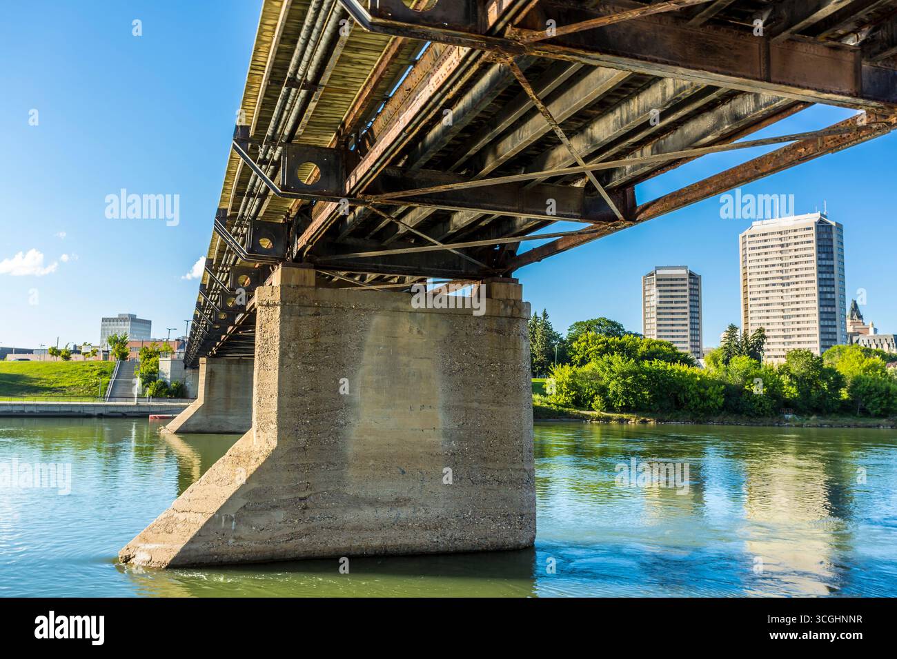A modern steel structure, the rebuilt Traffic Bridge spans the South Saskatchewan River, reconnecting downtown Saskatoon with the east side. Stock Photo