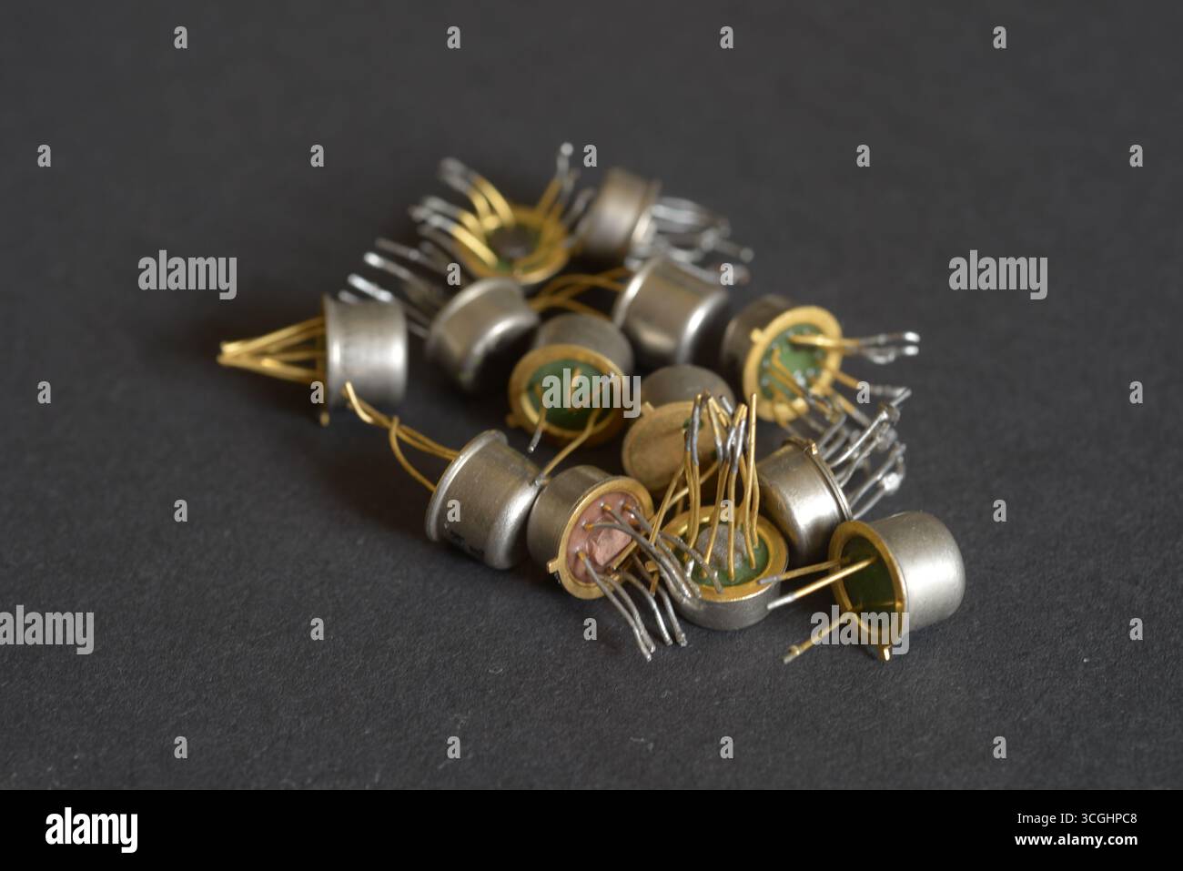 Antique electronic components with metallic housings on table. Stock Photo