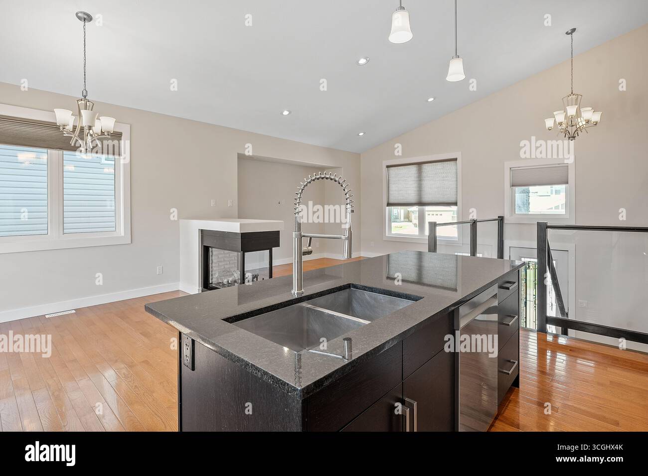 Kitchen with a black granite countertop and a sink. The kitchen is ...