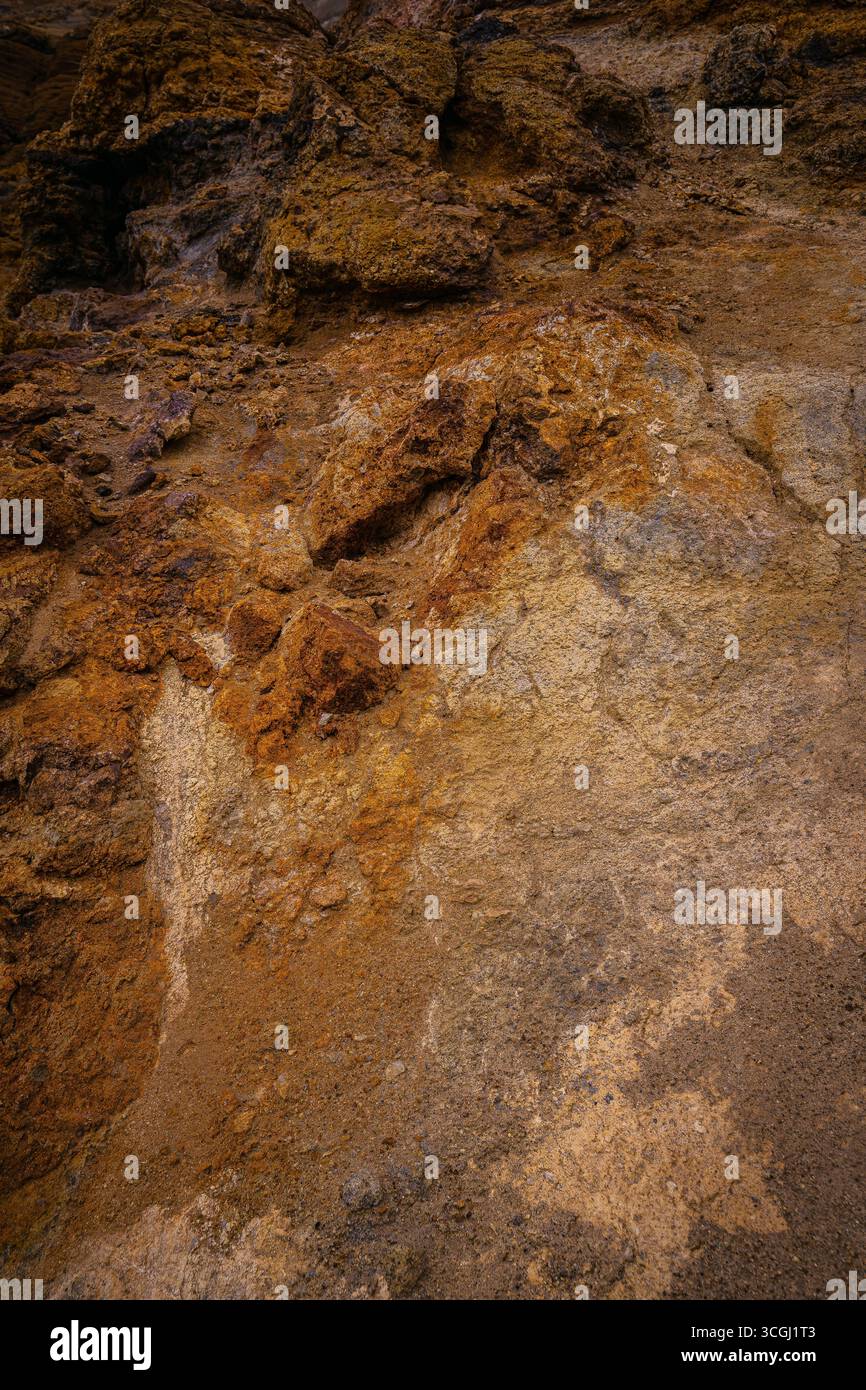 Golden and brown geothermal rock formations in Iceland show layers of ...