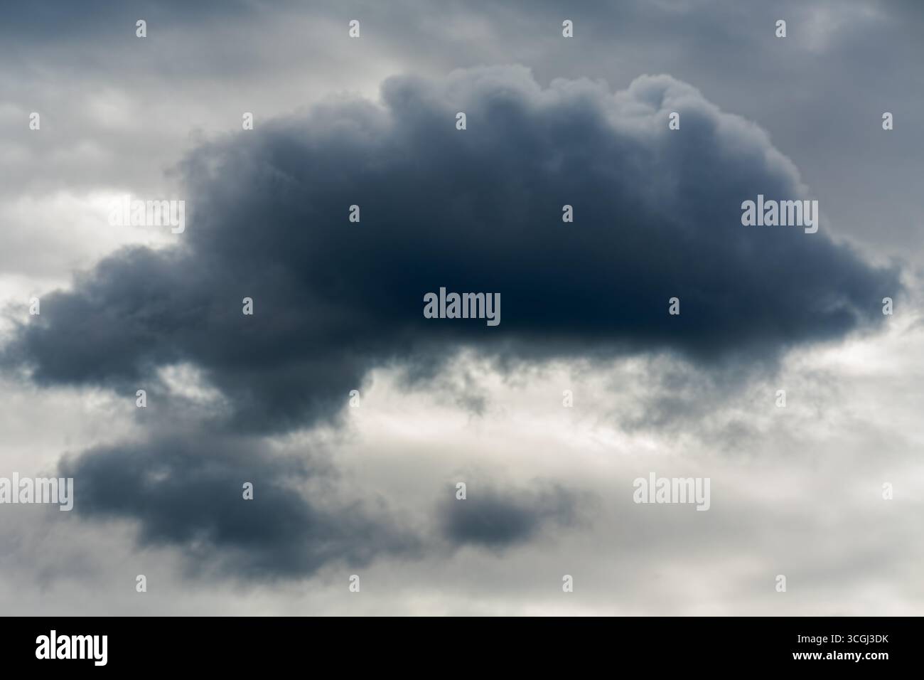 Cumulus clouds are low-level clouds that appear as dense, puffy formations with clearly defined edges. Stock Photo