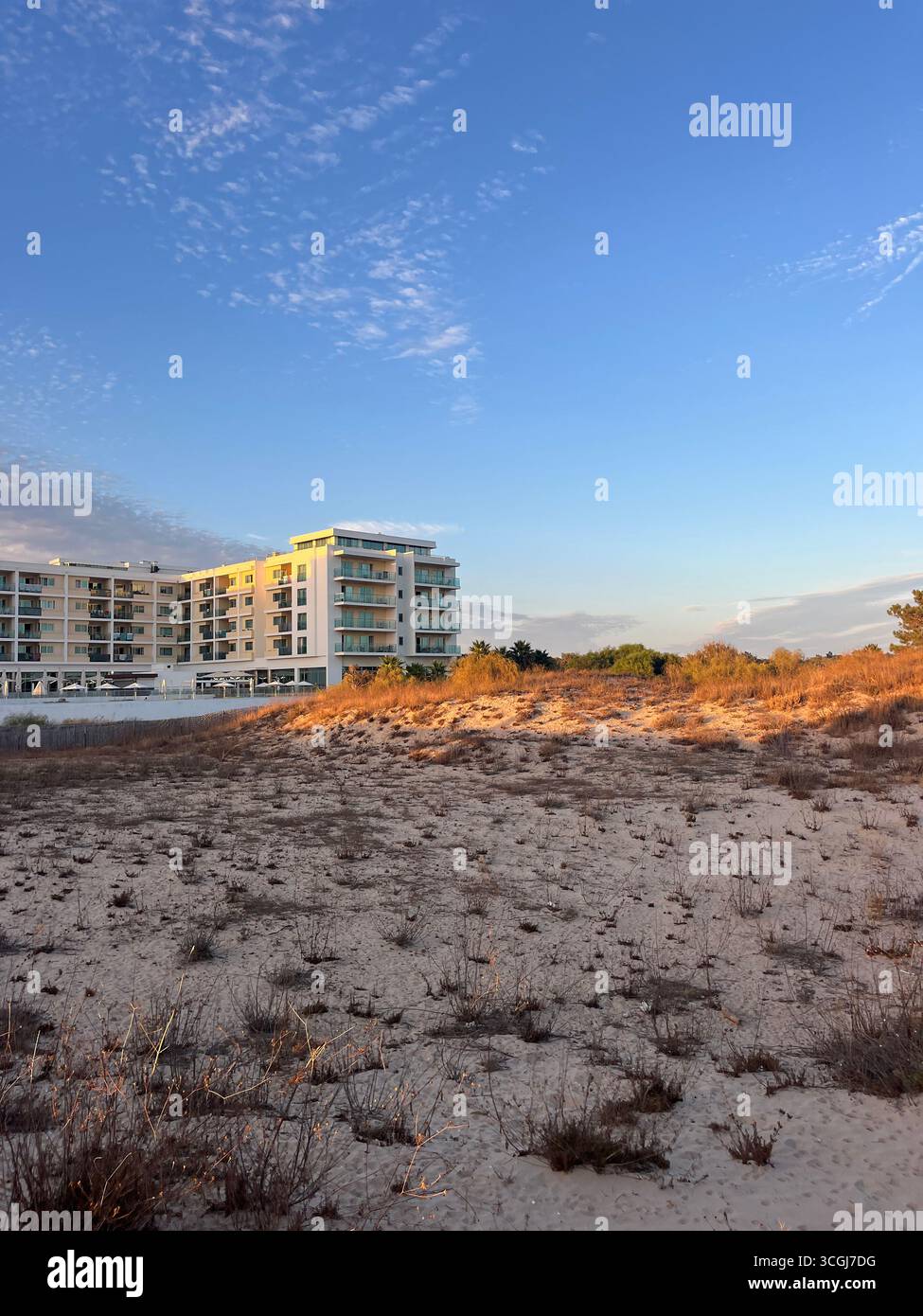 Modern beachfront hotel with sand dunes at Monte Gordo Beach, Algarve, Portugal. - Smartphone Captured Stock Image