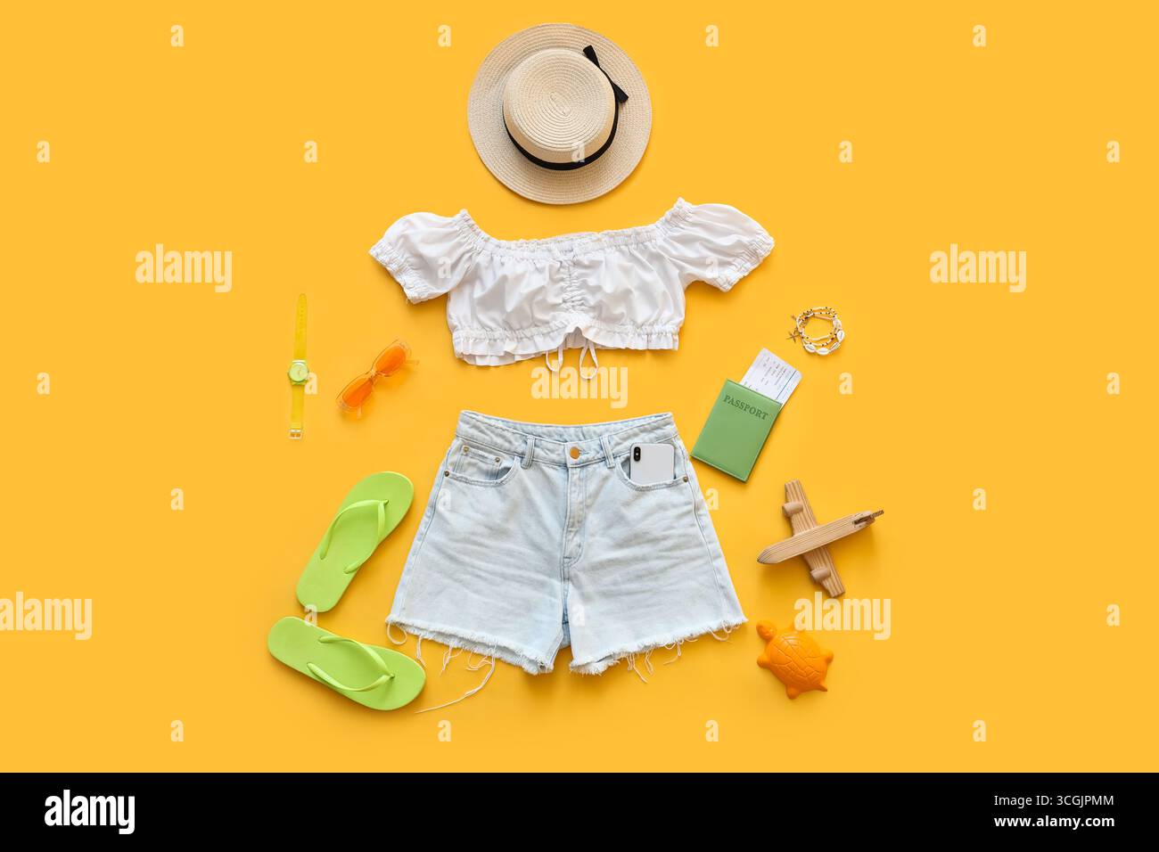 Composition with clothes and beach accessories on yellow background Stock Photo