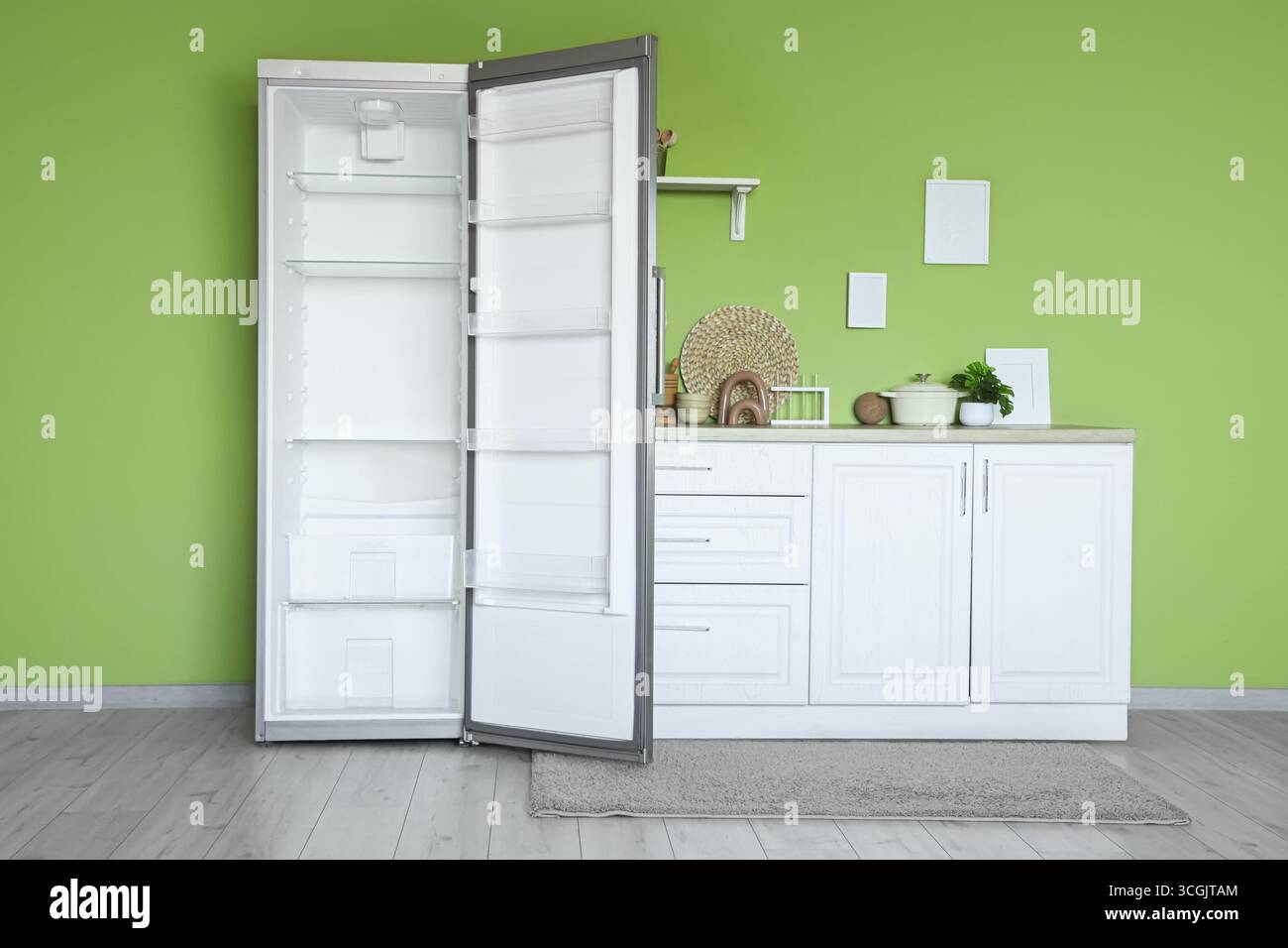 Interior of stylish kitchen with empty fridge and counters Stock Photo ...