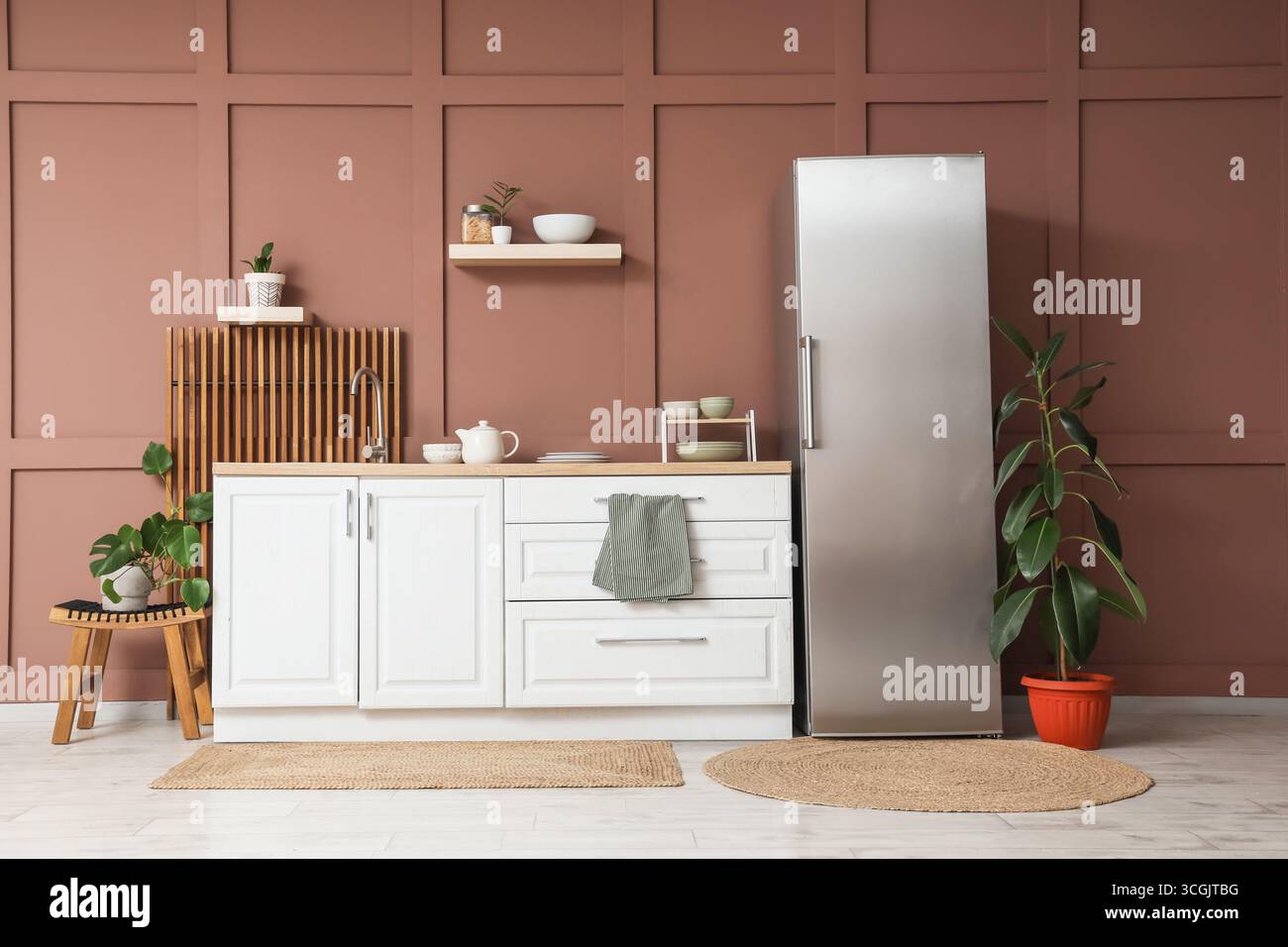 Interior of stylish kitchen with modern fridge, counters and shelves ...