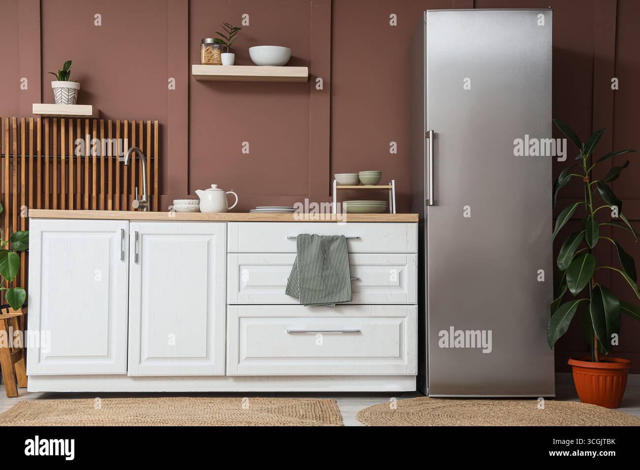 Interior of stylish kitchen with modern fridge, counters and shelves ...