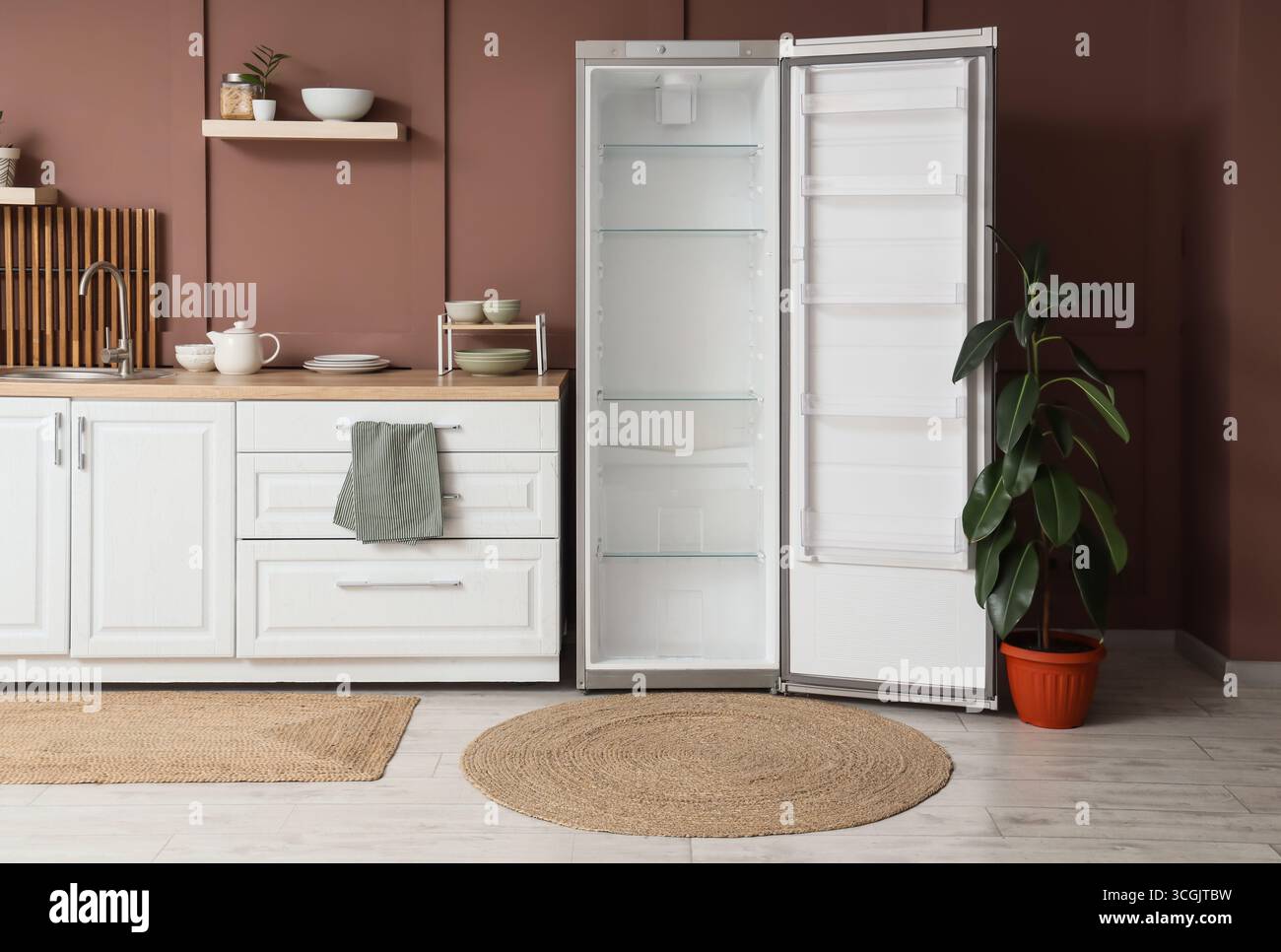 Interior of stylish kitchen with empty fridge, counters and shelf Stock ...