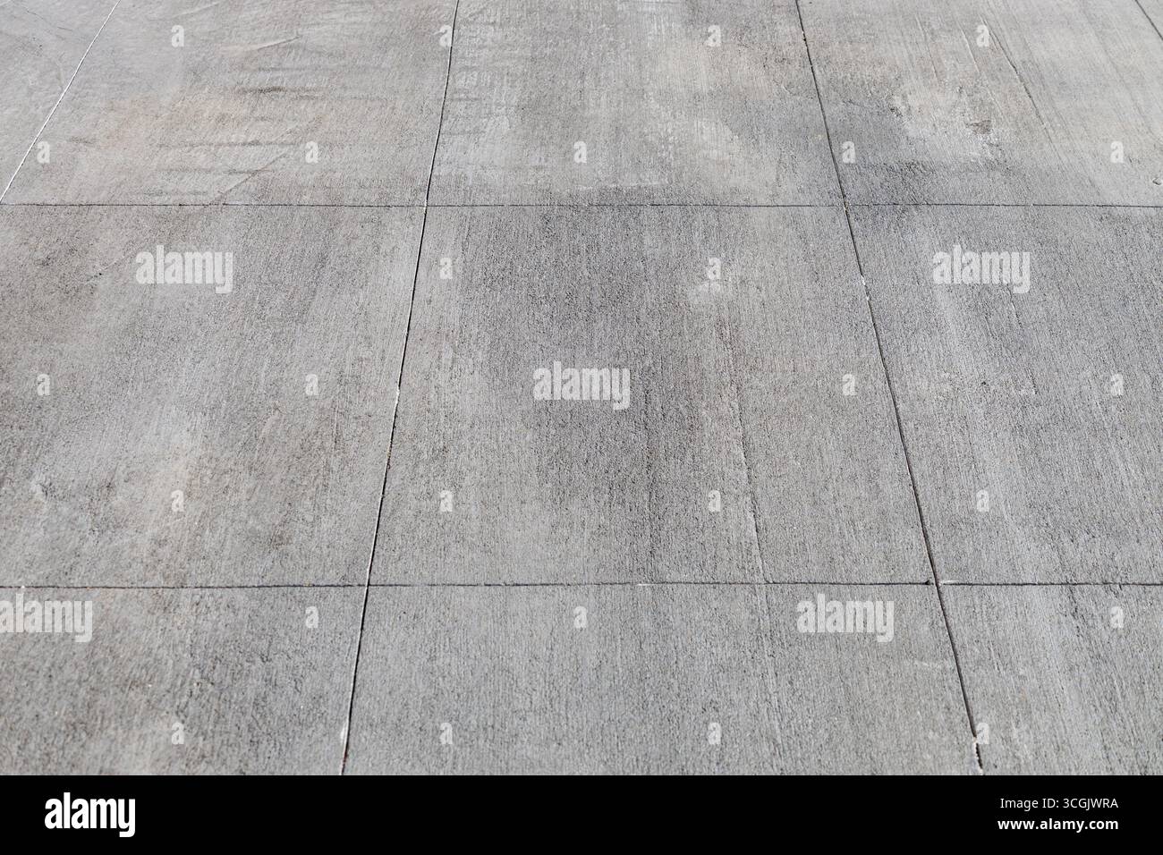 Full frame abstract texture background of a Rustic gray cement walking path with large rectangular lines Stock Photo
