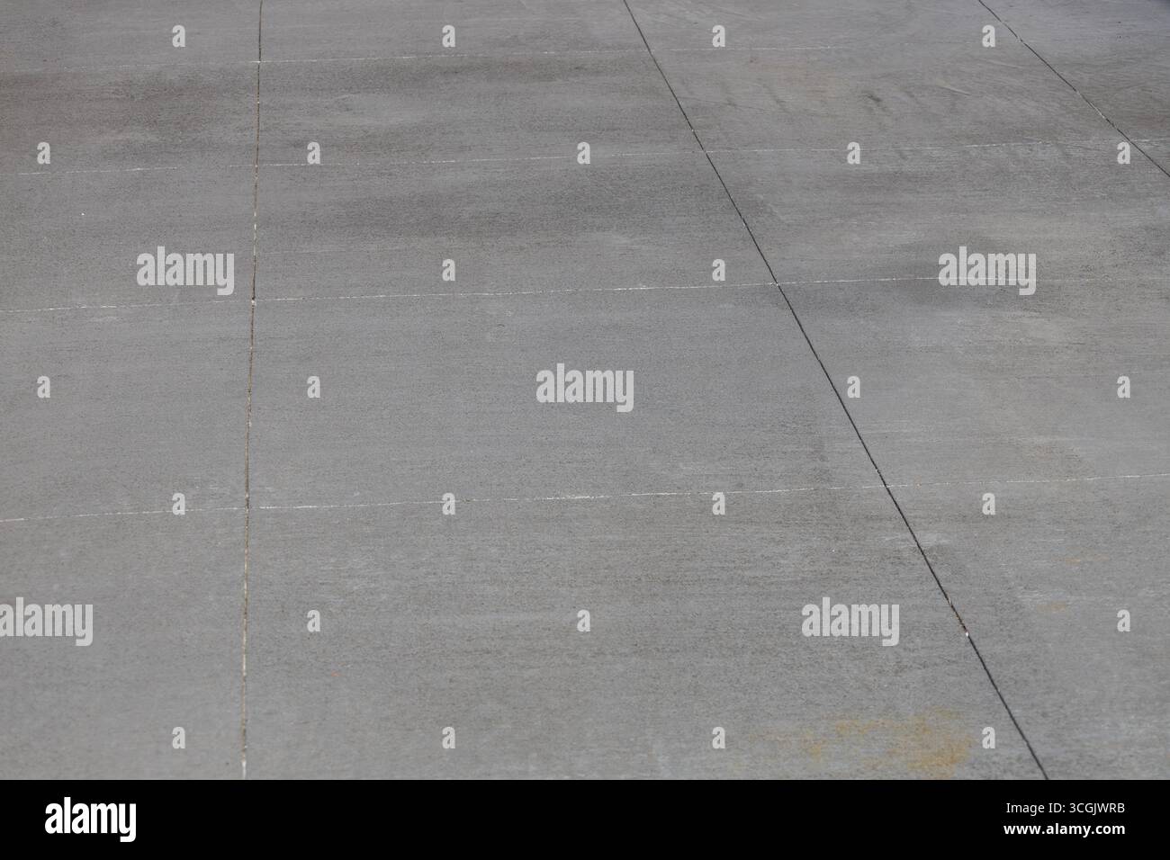 Full frame abstract texture background of a Rustic gray cement walking path with large rectangular lines Stock Photo
