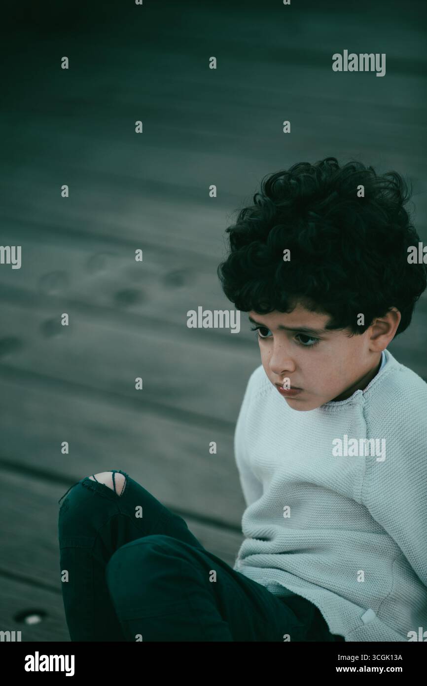 Scared liitle boy looking away Stock Photo